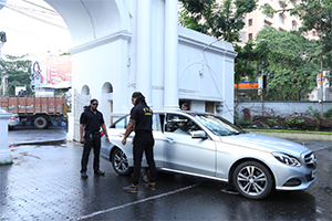 security personnel of pvs checking a car using a metal detector 1