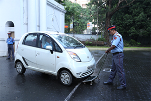 security personnel of pvs checking a car using a metal detector 2